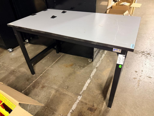 BENCH-TEK INDUSTRIAL WORKBENCH WITH HEAVY-DUTY BLACK STEEL FRAME AND GRAY WORK SURFACE.