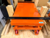 HYDRAULIC SCISSOR LIFT TABLE WITH FOOT-PUMP OPERATED LIFT MECHANISM, MANUAL RELEASE CONTROL, STEEL PLATFORM, CASTERS AND PUSH/PULL HANDLE.