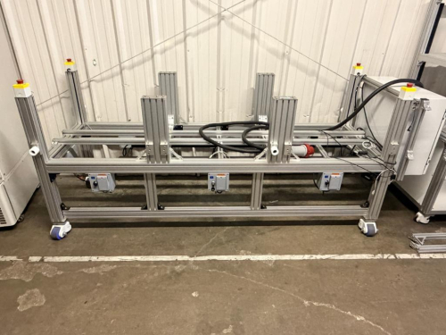 CUSTOM ALUMINUM EXTRUSION AUTOMATION / MATERIAL HANDLING FRAME WITH MULTIPLE VERTICAL SUPPORT STATIONS, ADJUSTABLE COMPONENT MOUNTS, CASTERS, EMERGENCY STOP CONTROLS, ELECTRICAL CONTROL ENCLOSURE AND INTEGRATED CONTROL CONNECTIONS.