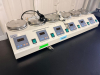 SIX-POSITION CONSTANT TEMPERATURE MAGNETIC AGITATOR WITH INDIVIDUAL STAINLESS STEEL HEATING/STIRRING PLATFORMS, DIGITAL TEMPERATURE CONTROLLERS AND INDEPENDENT POWER SWITCHES. INCLUDES CLAMP AND SUPPORT HARDWARE AS SHOWN.