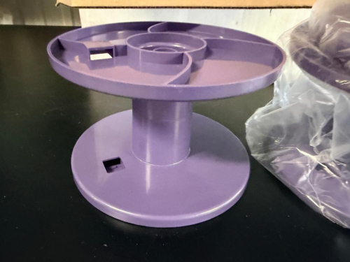 LOT OF PUTAWAY ID SERIAL TAPE UPTAKE REELS / SPOOLS, PURPLE MOLDED PLASTIC CONSTRUCTION. INCLUDES MULTIPLE REELS AS SHOWN.