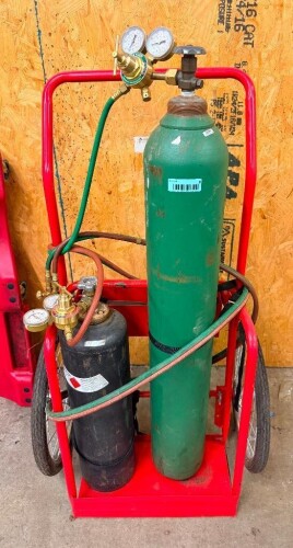 PORTABLE OXYGEN AND ACETYLENE CUTTING AND WELDING TORCH SET WITH OXYGEN CYLINDER, ACETYLENE CYLINDER, DUAL PRESSURE REGULATORS, PRESSURE GAUGES, RED AND GREEN GAS HOSES, CUTTING TORCH, AND TWO-WHEEL STEEL CYLINDER CART WITH STORAGE TRAY. INCLUDES ASSORTED
