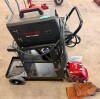 YESWELDER FLUX-135PRO MULTI-PROCESS INVERTER WELDING MACHINE WITH DIGITAL CONTROL DISPLAY, ADJUSTABLE WELDING SETTINGS, WIRE FEED SYSTEM, WELDING GUN, GROUND CLAMP, AND POWER CORD. INCLUDES TWO-WHEEL STEEL WELDING CART, AUTO-DARKENING WELDING HELMET, WELD