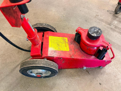 HEAVY-DUTY PNEUMATIC HYDRAULIC FLOOR JACK WITH LONG HANDLE, AIR-OPERATED LIFTING SYSTEM, DUAL WHEELS, AND SPRING-ASSISTED LIFTING MECHANISM.
