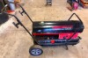 DYNA-GLO DELUX PROFESSIONAL GRADE ECOMAX 135,000 BTU PORTABLE FORCED AIR KEROSENE HEATER WITH ENCLOSED STEEL HEATING CHAMBER, INTEGRATED FUEL TANK, ADJUSTABLE THERMOSTAT, DIGITAL TEMPERATURE DISPLAY, AND WHEELED FRAME WITH TRANSPORT HANDLE.