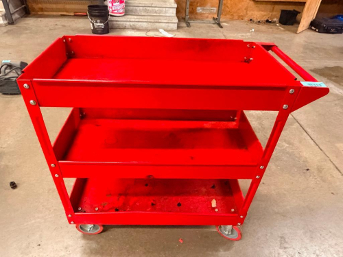 RED 3-TIER ROLLING STEEL SHOP UTILITY CART WITH OPEN STORAGE TRAYS, TUBULAR PUSH HANDLE, AND (4) SWIVEL CASTERS.