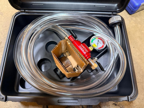 MATCO TOOLS HEAVY-DUTY TRUCK COOLING SYSTEM REFILLER KIT WITH PRESSURE GAUGE, REFILL VALVE ASSEMBLY, CLEAR HOSE, ASSORTED ADAPTERS AND MOLDED PLASTIC CARRYING CASE.
