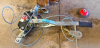 MANUAL CABLE COME-ALONG HAND WINCH WITH RATCHETING LEVER, STEEL WIRE ROPE, HEAVY-DUTY HOOKS, AND DOUBLE-PULLEY ASSEMBLY.