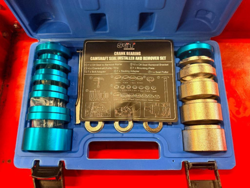 SGT CRANK BEARING AND CAMSHAFT SEAL INSTALLER AND REMOVER TOOL SET WITH ASSORTED SEAL ADAPTERS, INSTALLATION SLEEVES, PULLERS, AND ACCESSORIES IN MOLDED PLASTIC CARRYING CASE.