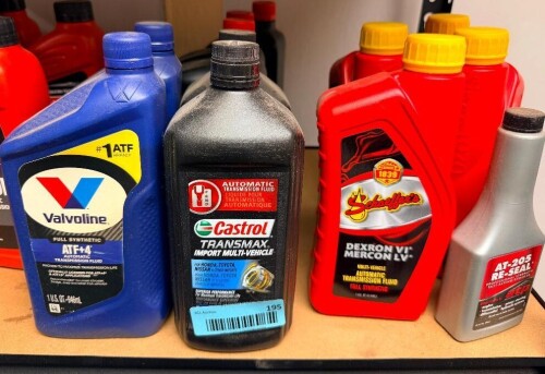 (1) LOT OF ASSORTED AUTOMOTIVE TRANSMISSION FLUIDS AND TRANSMISSION ADDITIVES, INCLUDING VALVOLINE FULL SYNTHETIC ATF+4, CASTROL TRANSMAX IMPORT MULTI-VEHICLE, SCHAEFFER'S DEXRON VI / MERCON LV AND LUBEGARD ATF ADDITIVE.