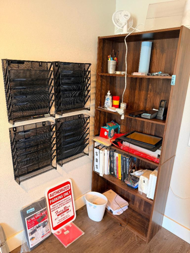 WOOD LAMINATE FIVE-SHELF BOOKCASE WITH (4) WALL-MOUNTED BLACK METAL MESH FIVE-POCKET FILE ORGANIZERS. NO CONTENTS INCLUDED.