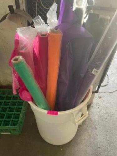 CONTENTS OF BIN - SEVERAL ROLLS OF PLASTIC TABLE COVERS.