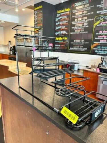 DESCRIPTION: (2) BLACK WIRE COFFEE RISER DISPLAY RACKS LOCATION: KITCHEN THIS LOT IS: ONE MONEY QTY: 1