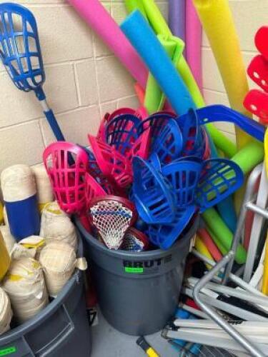 TRASH CAN FULL OF GYM LACROSS STICKS AND NOODLES