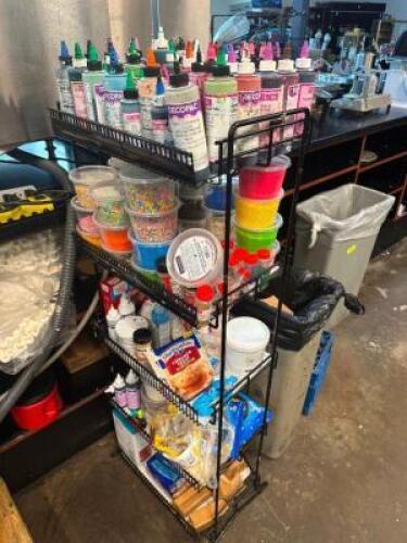 ALL FROSTING AND TOPPING BEHIND BAKER COUNTER.