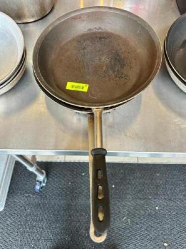 NAME: (2)- SKILLETS DESCRIPTION: (2)- SKILLETS SIZE: 14" LOCATION: FRONT ENTRANCE QTY: 2