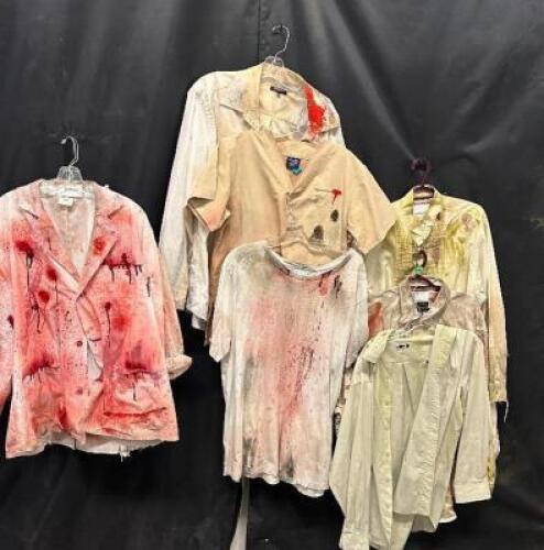 DESCRIPTION (7) ASSORTED ACTORS SHIRTS W/ FAKE BLOOD, DIRT AND GRIME ADDITIONAL INFORMATION EVERY STAIN, EVERY BLEMISH, TELLS A STORY OF HORROR AND DE
