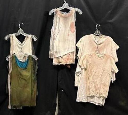 DESCRIPTION (12) ASSORTED ACTORS SHIRTS AND CAMIS W/ FAKE DIRT AND GRIME ADDITIONAL INFORMATION EVERY STAIN, EVERY BLEMISH, TELLS A STORY OF HORROR AN