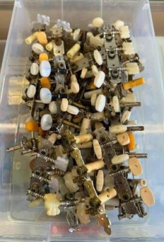 BIN OF GUITAR TUNER PIECES