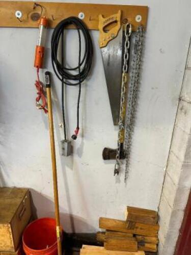 HAND SAW, AXE, EXTENSION CORD, CHAIN, AND WORK LIGHT.