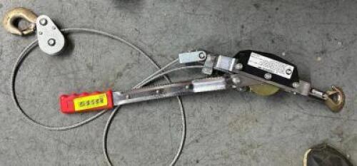 1 TON COME ALONG W/ SEVERAL SECTION OF CHAIN.