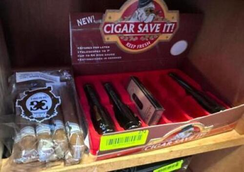 (3) CIGAR HOLDERS AND (1) PARTIAL PACK OF CIGARS.
