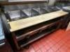 DESCRIPTION WELLS FOUR WELL ELECTRIC STEAM TABLE W/ CUTTING BOARD FRONT. BRAND / MODEL: WELLS ADDITIONAL INFORMATION 208 VOLT 3 PHASE. VERIFIED IN WOR