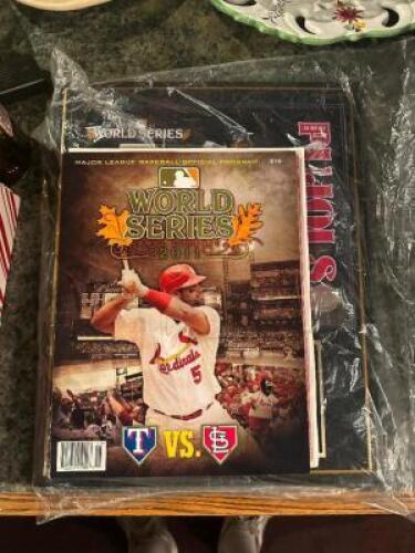 DESCRIPTION: 2011 WORLD SERIES PROGRAM AND ALBERT PUJOLS 3 HR GAME PLAQUE ADDITIONAL INFORMATION: SOLD AS SET. LOCATION: ROOM 3 THIS LOT IS: ONE MONEY