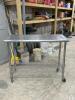 STAINLESS TABLE WITH WIRE UNDERSHELF ON CASTERS - 3