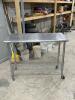 STAINLESS TABLE WITH WIRE UNDERSHELF ON CASTERS - 4