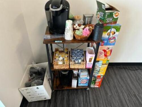 DESCRIPTION (2) KEURIG MACHINES W/ WOODEN SHELVE AND ASSORTED SUPPLIES. BRAND / MODEL: KEURIG LOCATION FRONT QTY 1
