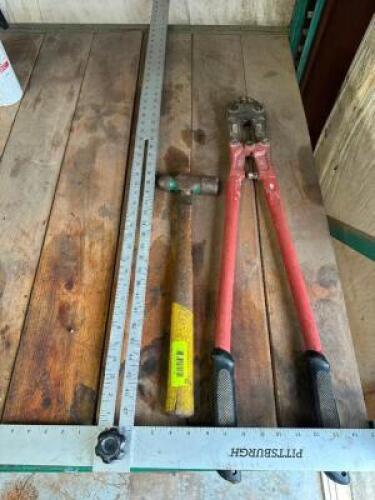 BOLT CUTTERS, HAMMER, AND T SQUARE.