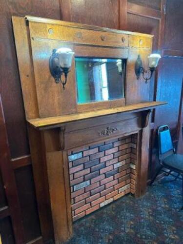 WOODEN FIRE PLACE MANTLE AND SURROUND W/ (2) SCONCE LIGHTS.