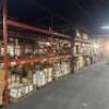 (9) - SECTIONS OF 12' TEAR DROP PALLET RACKING WITH WOOD DECKING