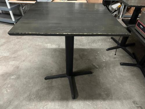 DESCRIPTION 36" X 36" GREY WOODEN TABLE W/ PUB BASE. SIZE 36" X 36" X 42" T LOCATION BAY 6 QTY 1
