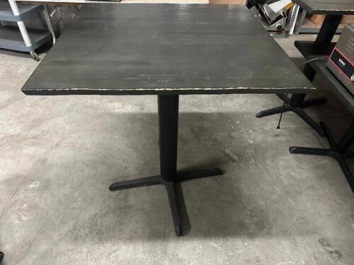 DESCRIPTION 36" X 36" GREY WOODEN TABLE W/ PUB BASE. SIZE 36" X 36" X 42" T LOCATION BAY 6 QTY 1