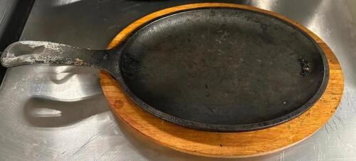DESCRIPTION (16) 10" CAST IRON FAJITA SKILLETS AND (13) WOODEN CHARGERS. THIS LOT IS: SOLD BY THE PIECE LOCATION BAY 6 QTY 13