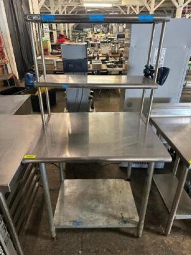 DESCRIPTION 36" X 30" STAINLESS TABLE W/ TWO TIER RISER SHELF. SIZE 36" X 30" LOCATION BAY 6 QTY 1
