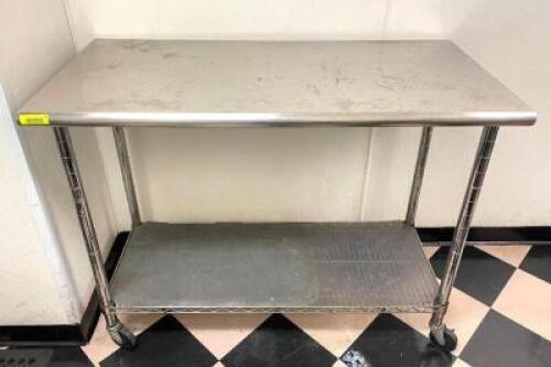 50" X 24" STAINLESS TABLE ON CASTERS.