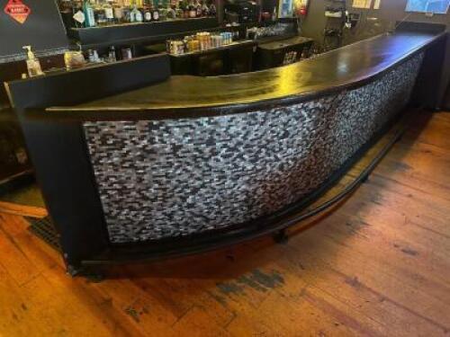 DESCRIPTION 200" X 26" BLACK COMPOSITE BAR TOP WITH WOODEN TRIM, CAST IRON FOOT RAIL, AND WOODEN ARCH BAR BACK. ADDITIONAL INFORMATION LOGO MIRROR IS