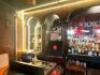DESCRIPTION 200" X 26" BLACK COMPOSITE BAR TOP WITH WOODEN TRIM, CAST IRON FOOT RAIL, AND WOODEN ARCH BAR BACK. ADDITIONAL INFORMATION LOGO MIRROR IS - 10