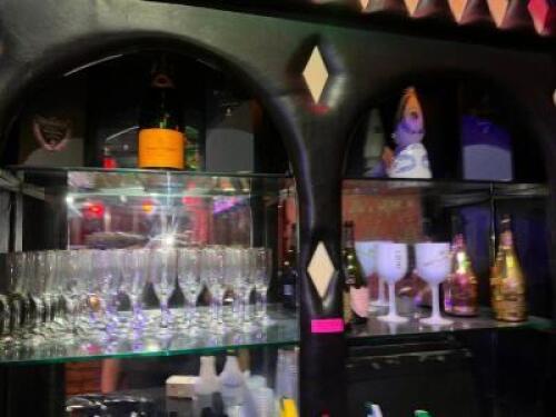 DESCRIPTION CONTENTS OF HUTCH - ASSORTED FLUTE GLASSES, EMPTY BOTTLES, AND MISC. LOCATION BACK BAR QTY 1