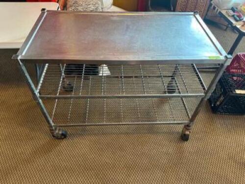 50" X 24" STAINLESS TABLE ON CASTERS.
