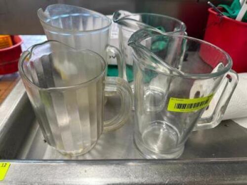 (4) ASSORTED GLASS AND PLASTIC PITCHERS.