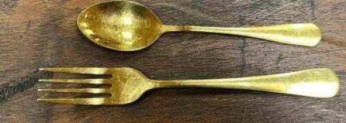 DESCRIPTION (36) SETS OF GOLD STAINLESS SPOONS, AND FORKS. ADDITIONAL INFORMATION W/ RACK THIS LOT IS: SOLD BY THE PIECE LOCATION BANQUET ROOM TABLE 1